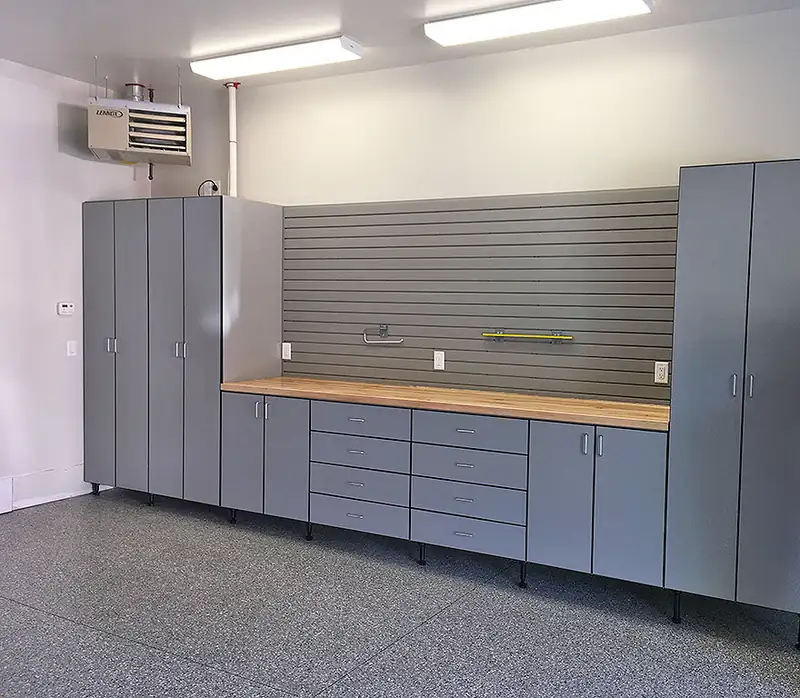 Custom gray garage cabinets and workbench on a flake epoxy floor