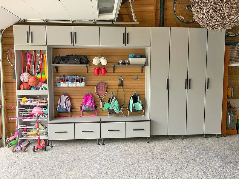 Finished garage makeover with cabinets, slatwall storage and a flake floor